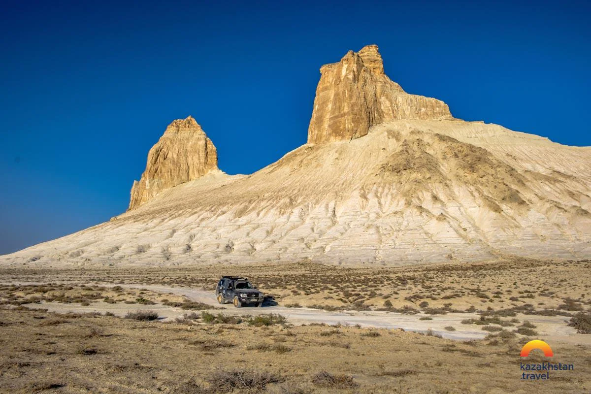 An off-road vehicle below the chalk peaks of Bozjyra
